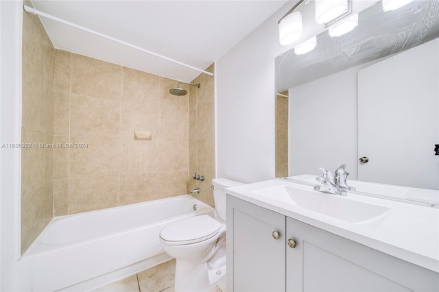 full bathroom with tile floors, tiled shower / bath combo, toilet, and vanity with extensive cabinet space