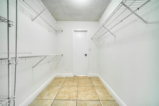 spacious closet featuring light tile floors