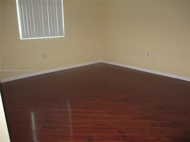 unfurnished room with dark hardwood / wood-style floors