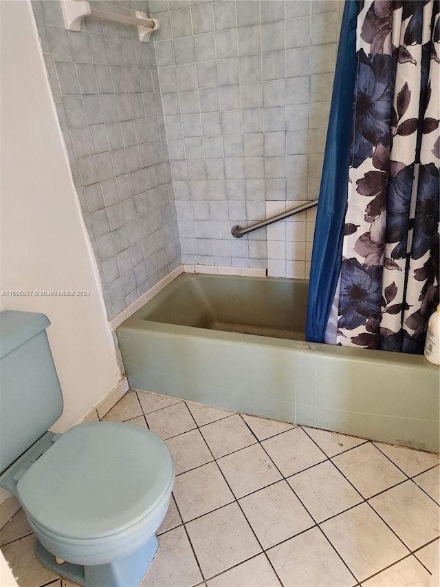 bathroom with tile flooring, shower / bath combo, and toilet