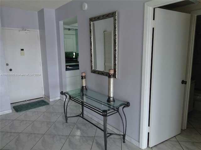 corridor with light tile patterned floors