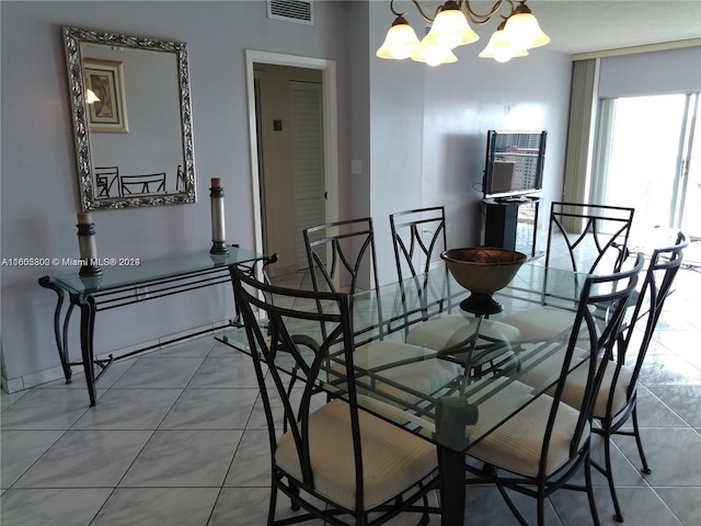 tiled dining space featuring an inviting chandelier