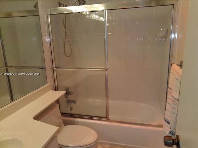 full bathroom featuring shower / bath combination with glass door, vanity, and toilet