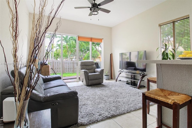 tiled living room with ceiling fan