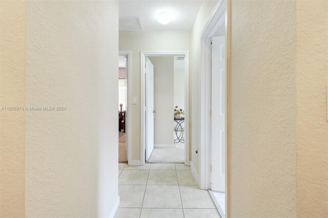 hall featuring light colored carpet