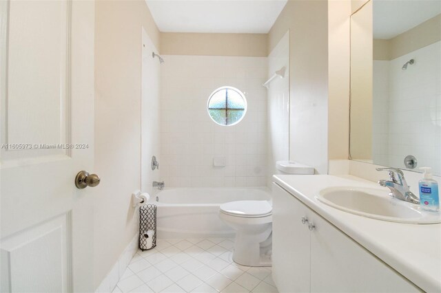 full bathroom with tile patterned floors, vanity, tiled shower / bath combo, and toilet