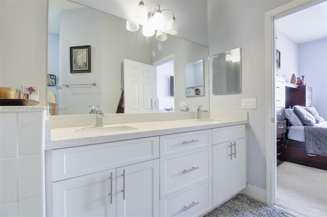 bathroom featuring dual vanity and a chandelier