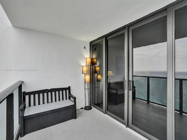 bedroom featuring a wall of windows and a water view