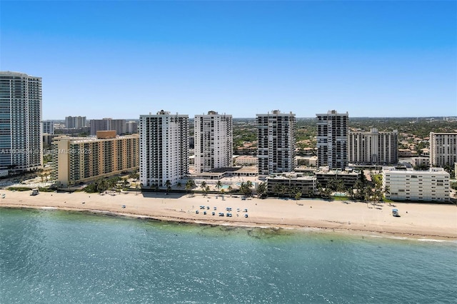 birds eye view of property featuring a beach view and a water view