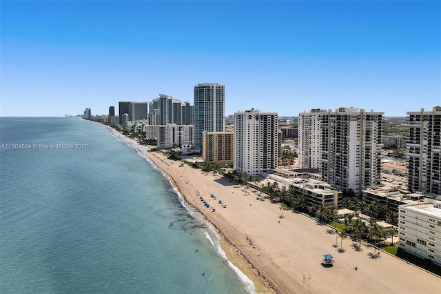 birds eye view of property featuring a beach view and a water view