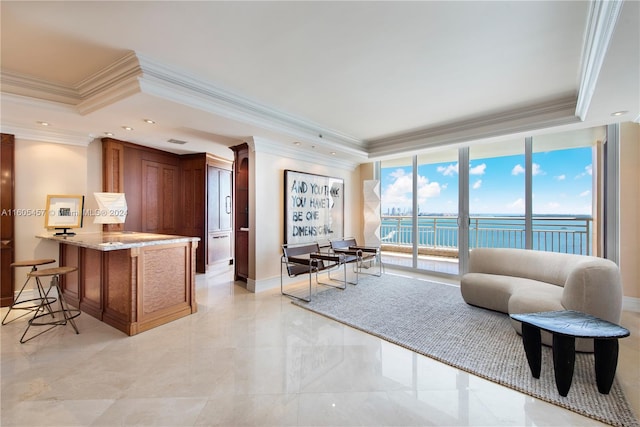 living room featuring a water view, expansive windows, and ornamental molding