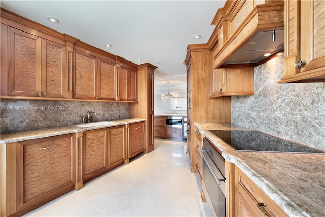 kitchen with stainless steel oven, sink, tasteful backsplash, premium range hood, and black electric cooktop