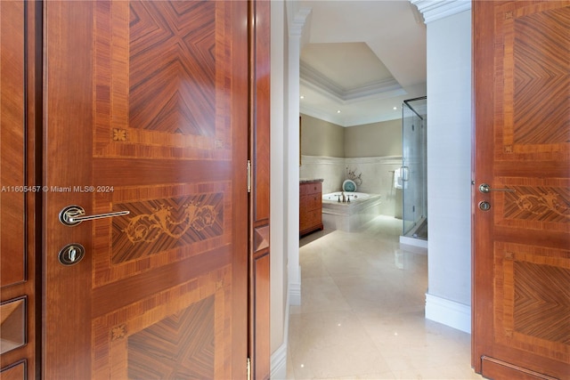 corridor featuring tile walls and ornamental molding