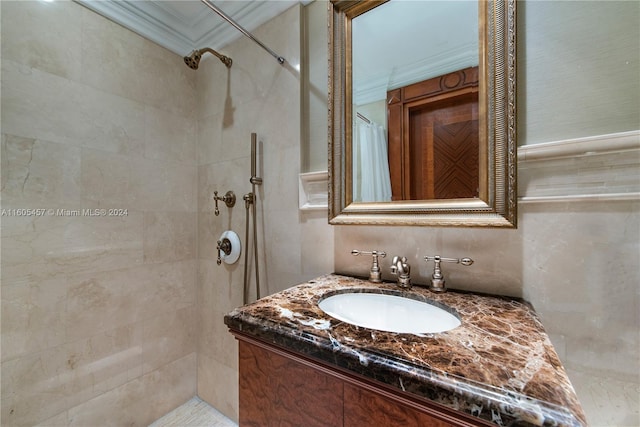 bathroom with tiled shower and vanity