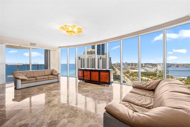 living room with a water view, expansive windows, and crown molding