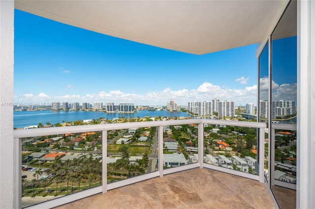 balcony featuring a city view and a water view