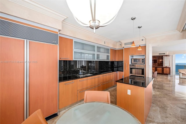 kitchen featuring a sink, ornamental molding, built in appliances, modern cabinets, and a center island