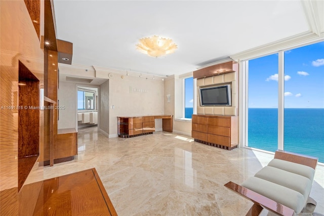 living room with floor to ceiling windows, marble finish floor, crown molding, and baseboards