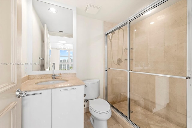 bathroom featuring vanity, toilet, visible vents, and a stall shower