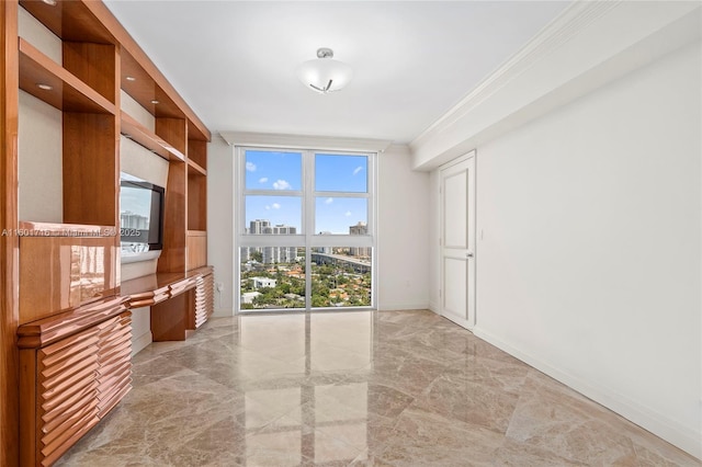 spare room with a wall of windows, baseboards, marble finish floor, and ornamental molding