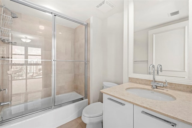 full bathroom with combined bath / shower with glass door, visible vents, toilet, and vanity