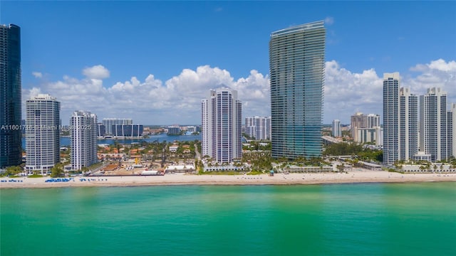 exterior space featuring a water view, a view of city, and a beach view