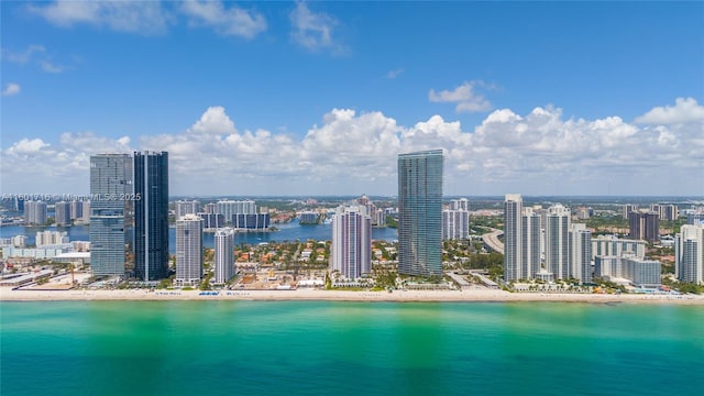 drone / aerial view featuring a water view and a view of city