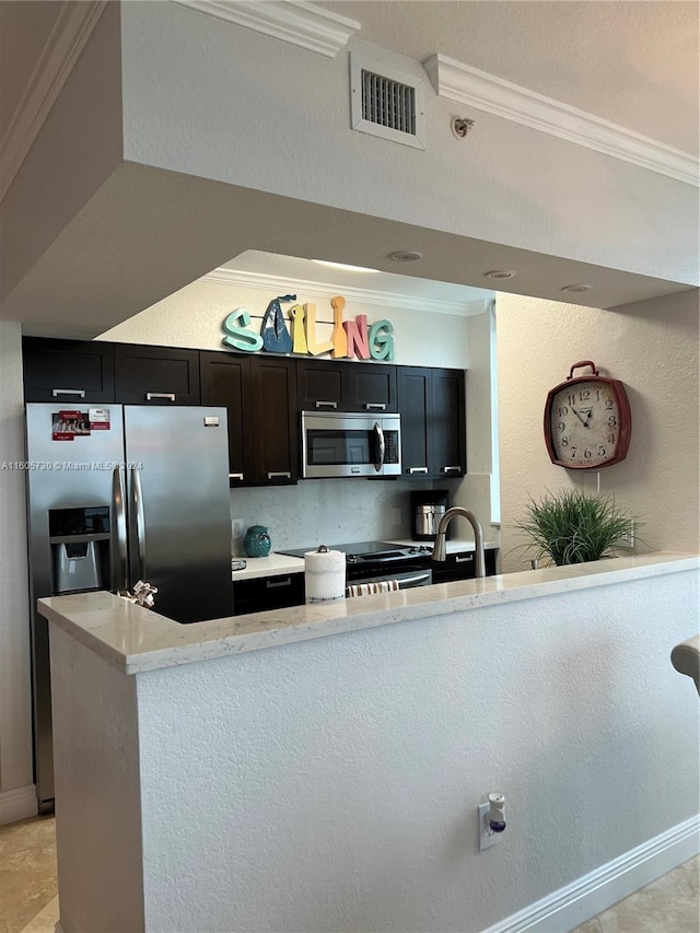 kitchen featuring crown molding, backsplash, light tile floors, sink, and appliances with stainless steel finishes