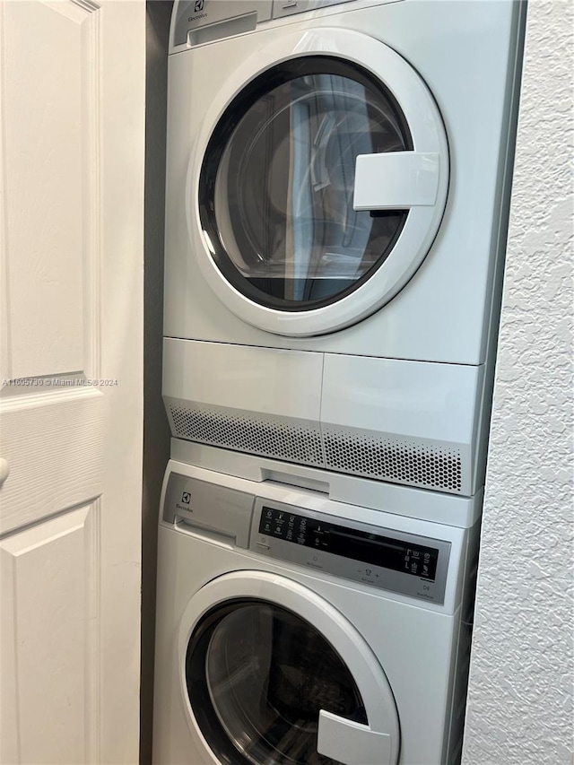 laundry room with stacked washer and dryer