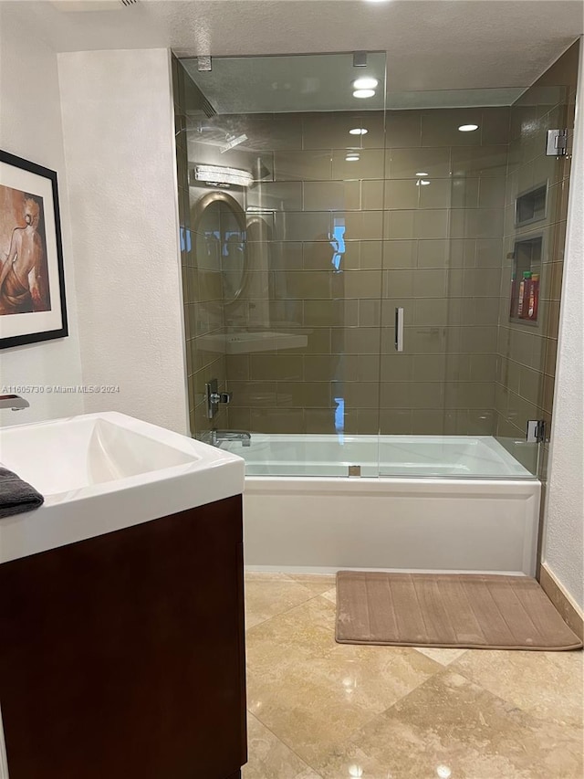 bathroom featuring enclosed tub / shower combo, tile flooring, and vanity