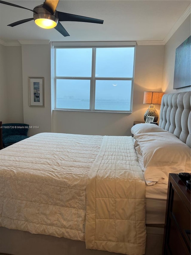 bedroom featuring ceiling fan and ornamental molding