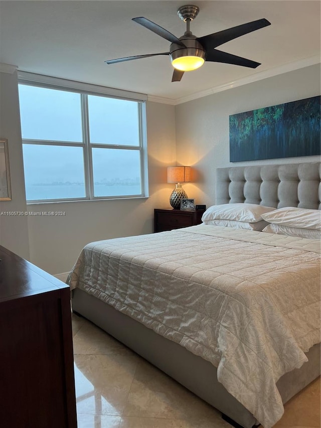 bedroom featuring tile floors, ceiling fan, and ornamental molding