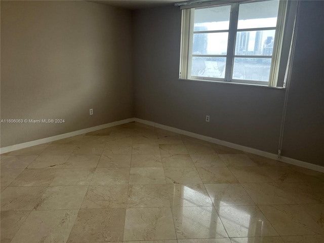 empty room with light tile patterned floors