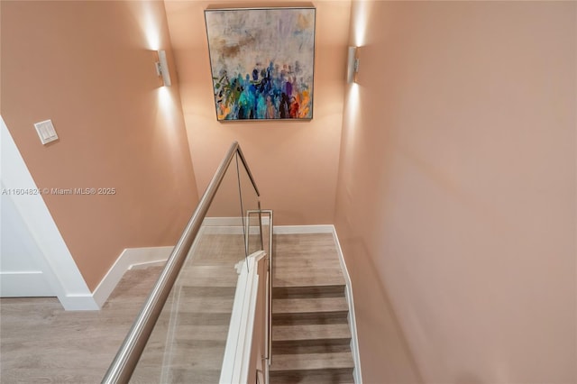 stairway featuring wood-type flooring