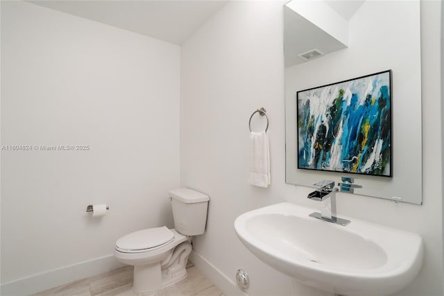 bathroom featuring tile patterned floors, sink, and toilet