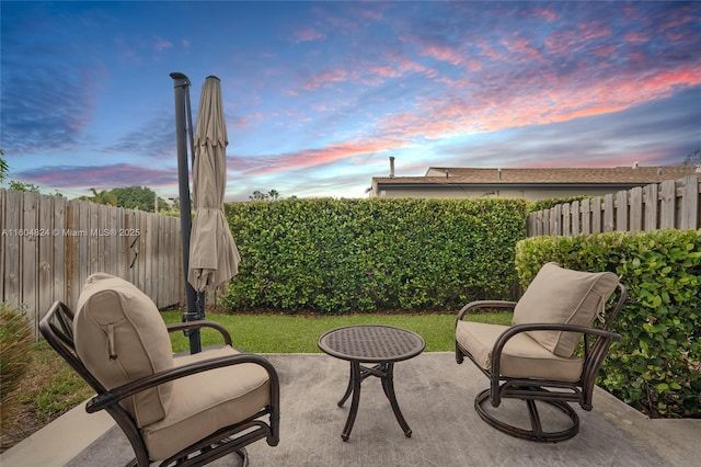 view of patio terrace at dusk