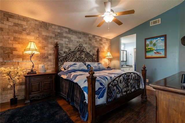 bedroom with dark hardwood / wood-style floors, a textured ceiling, vaulted ceiling, and ceiling fan