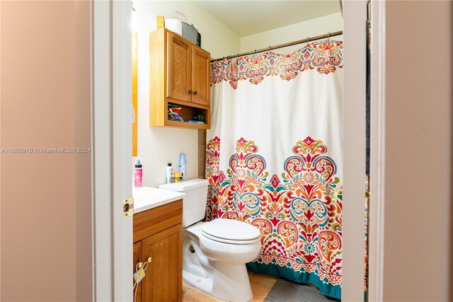 bathroom with vanity, tile patterned flooring, and toilet