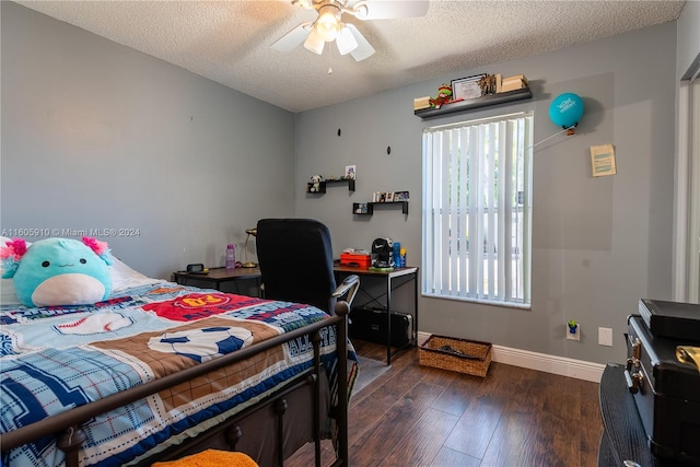 bedroom featuring dark hardwood / wood-style floors, a textured ceiling, multiple windows, and ceiling fan