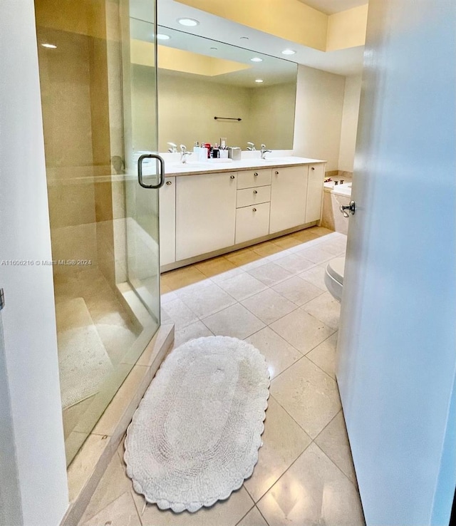 bathroom with toilet, walk in shower, vanity, and tile patterned flooring