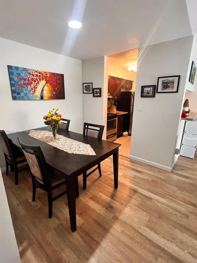 dining space featuring light hardwood / wood-style floors