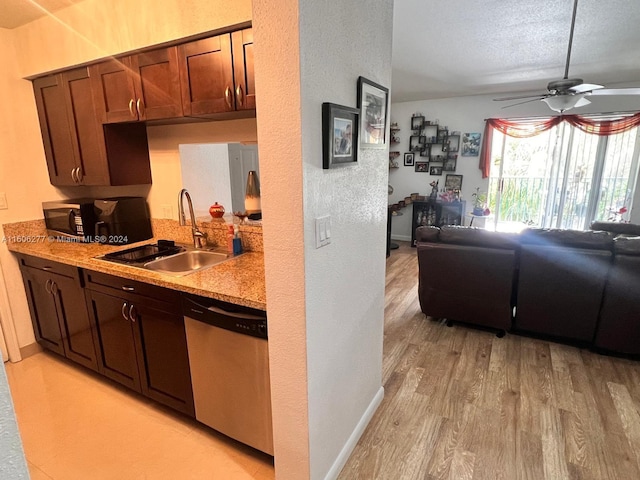 kitchen with light hardwood / wood-style floors, a textured ceiling, stainless steel dishwasher, sink, and ceiling fan