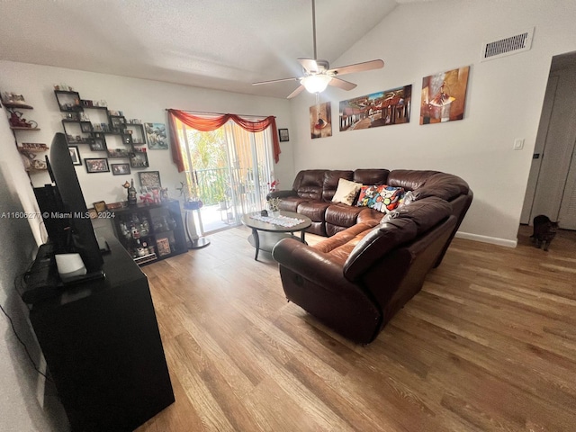 living room with ceiling fan, vaulted ceiling, and hardwood / wood-style flooring