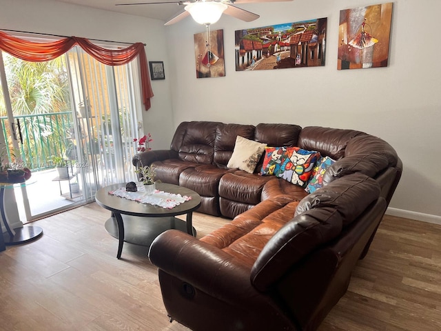 living room featuring ceiling fan and hardwood / wood-style floors