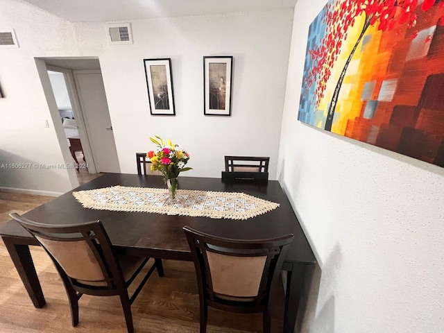 dining space with hardwood / wood-style flooring