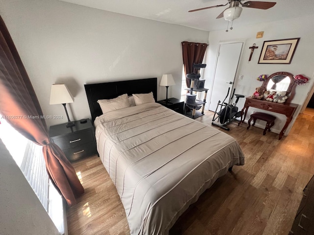 bedroom featuring hardwood / wood-style flooring and ceiling fan