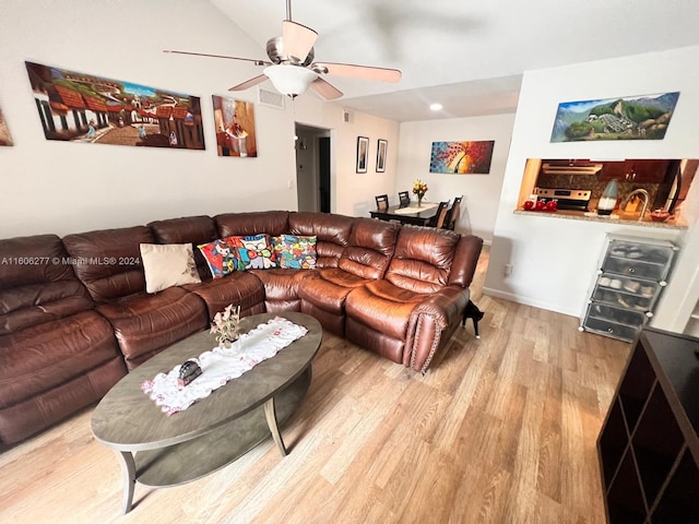 living room featuring hardwood / wood-style floors, ceiling fan, and lofted ceiling