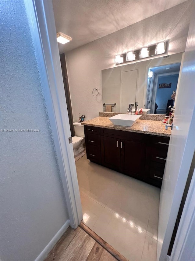 bathroom with vanity and a textured ceiling