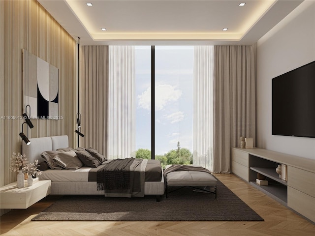 bedroom featuring a tray ceiling, floor to ceiling windows, and light parquet flooring