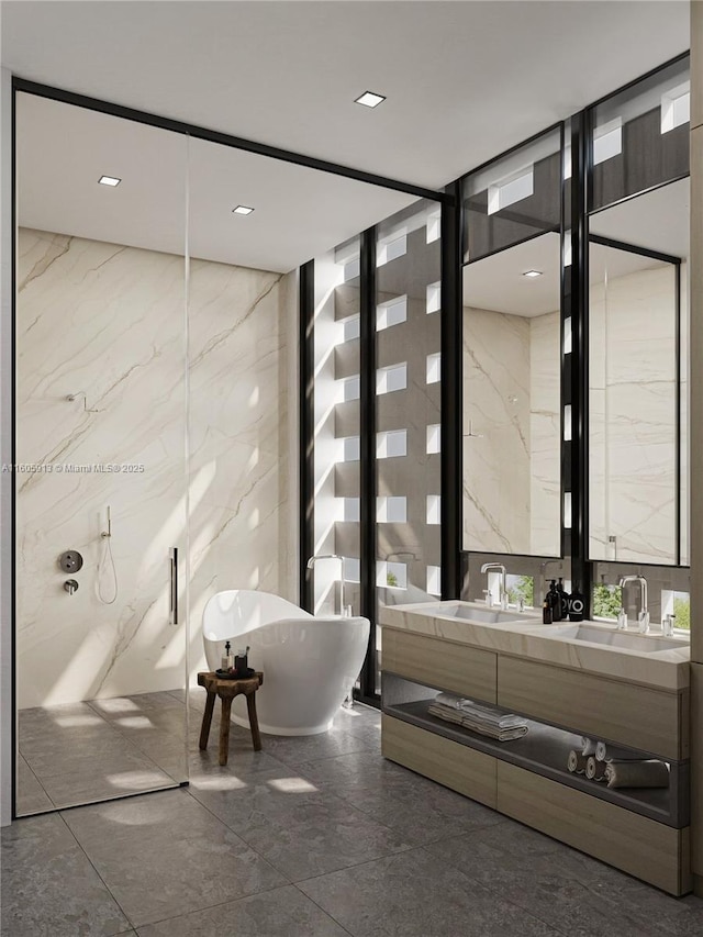 bathroom featuring a tub to relax in, vanity, and tile walls